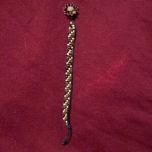 Yellow, black, and white bracelet with flower button